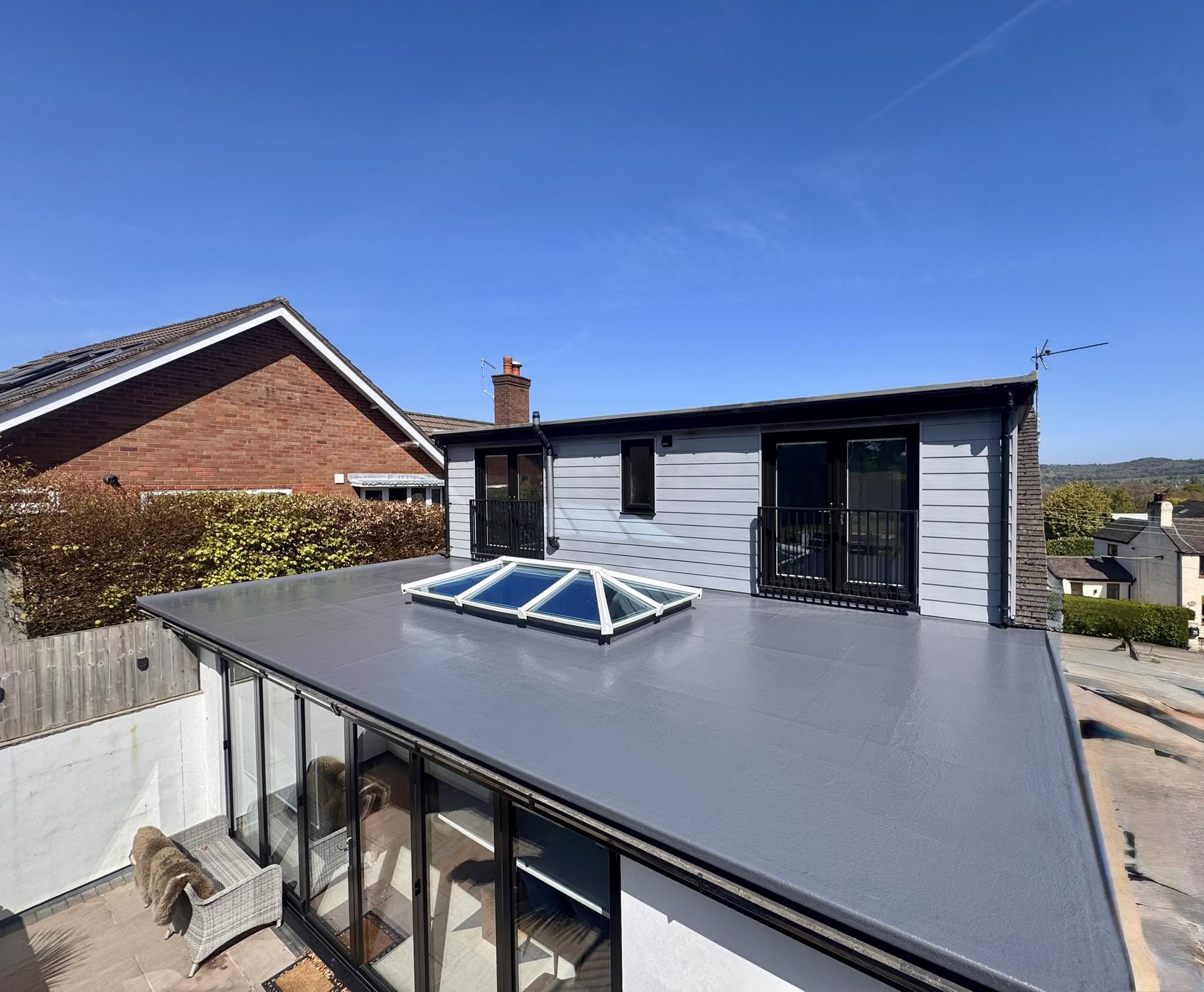 Finished grey GRP fibreglass flat roof with a glass roof lantern on a Staffordshire home