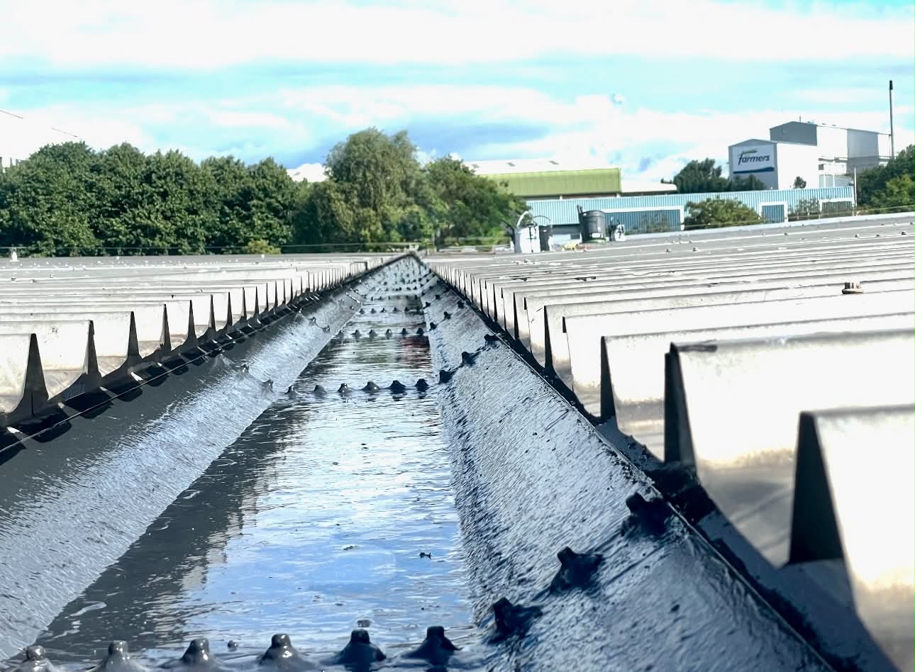 Industrial valley gutter freshly lined with liquid applied waterproofing